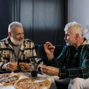 older adults enjoying a pizza