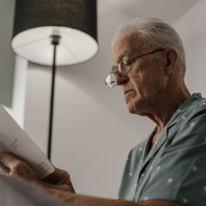 a senior man reading a book