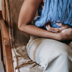a woman clutching her stomach in pain